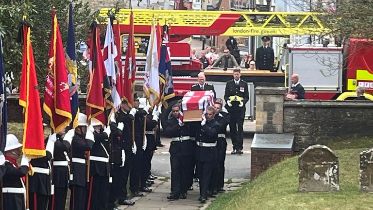 The coffin of firefighter Martyn Sadler is carried into St Edburg's Church in Bicester for his funeral. The firefighter lost his life in the