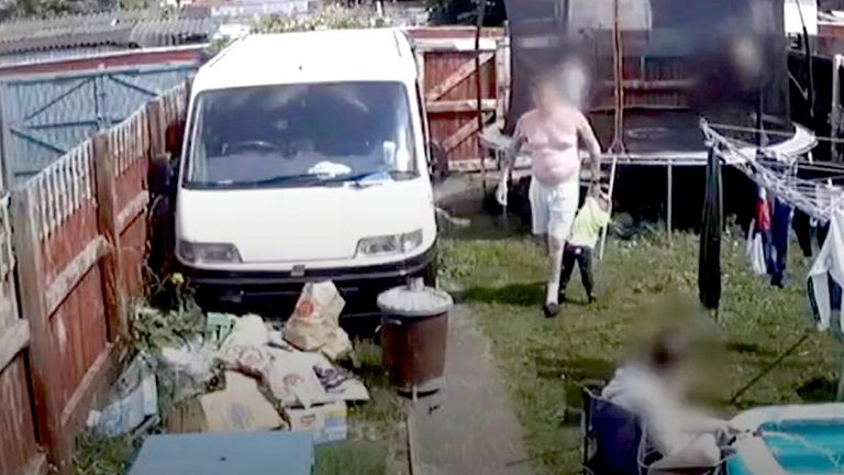 Michael Ives carrying two-year-old EthanIves-Griffiths in the back garden of the family home in Garden City.
Pic:North Wales Police
