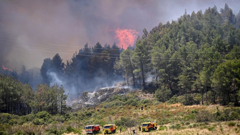 Firefighters work to contain a fire  in the Fontfroide massif  near Narbonne