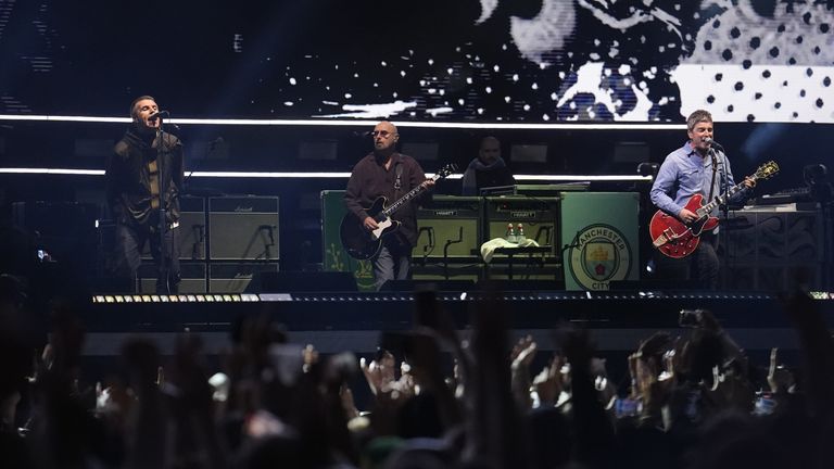 Fans sang along and held up their phones to film as Oasis performed. Pic: PA