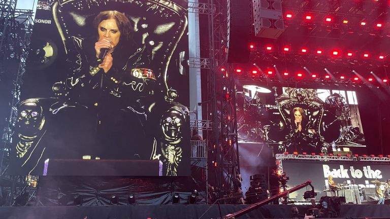 Ozzy Osbourne sings while sitting on a black throne