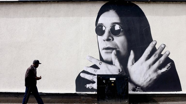 A man passes by a mural of Ozzy Osbourne, the former Black Sabbath frontman, ahead of the funeral cortege, in Birmingham.
Pic Reuters