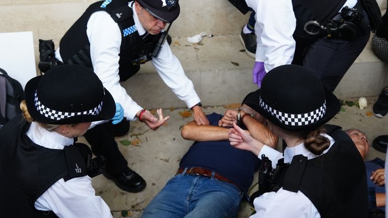Metropolitan Police officers remove people from a protest by the Defend Our Juries group in support of Palestine Action. Pic: PA