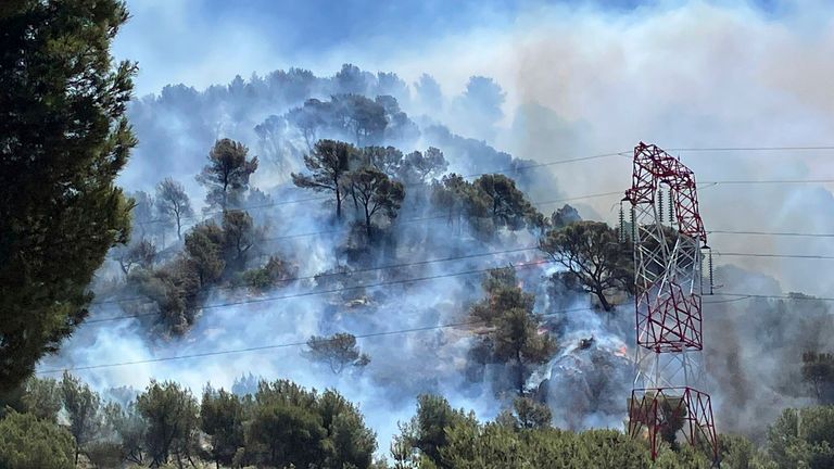 Smoke rises during a wildfire in Pennes-Mirabeau, near Marseille, southern France.
Pic: SDIS13/AP