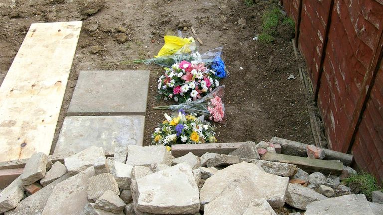 Floral tributes laid in the garden in Margate where the remains of 15-year-old Vicky Hamilton were found nearly three weeks ago - more than