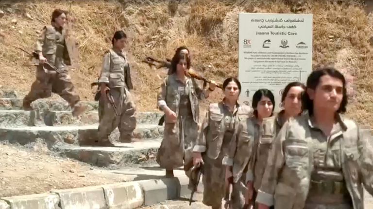 Armed PKK fighters arrive ahead of a disarming ceremony in Sulaimaniya, Iraq.
Pic: Reuters