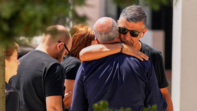 Joaquim, center, father of Liverpool forward Diogo Jota and his brother, is embraced at a church where their bodies have been brought for a wake and funeral, in Gondomar, near Porto, Portugal, on Friday, July 4, 2025. (AP Photo/Manu Fernandez)
