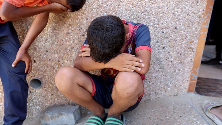 Boys cry following the incident near the Rafah aid centre. Pic: Reuters