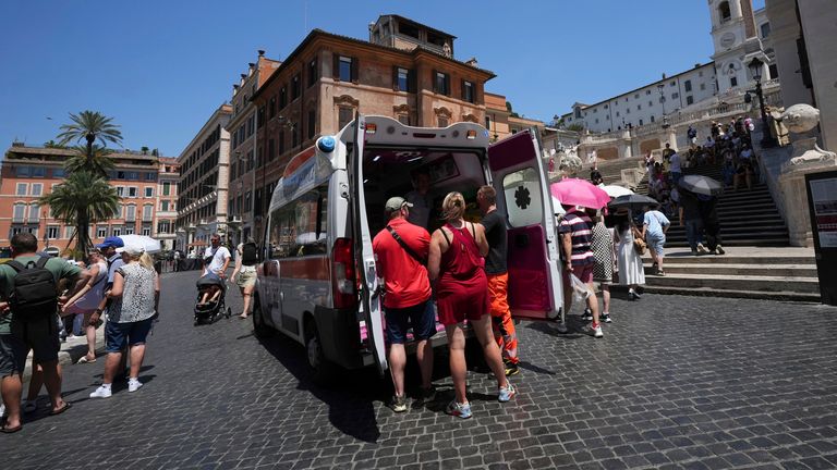 Paramedics provide aid next to the Spanish Steps, in Rome, Italy, Tuesday, July 1, 2025. (AP Photo/Andrew Medichini)
