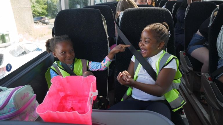 Girls giggle on the coach on the way to the beach