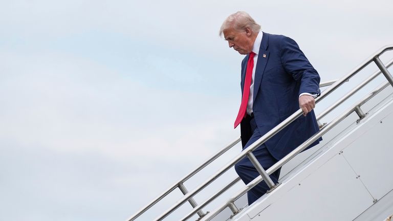 President Donald Trump disembarks from Air Force One as he arrives at Prestwick Airport in Scotland.
Pic: AP