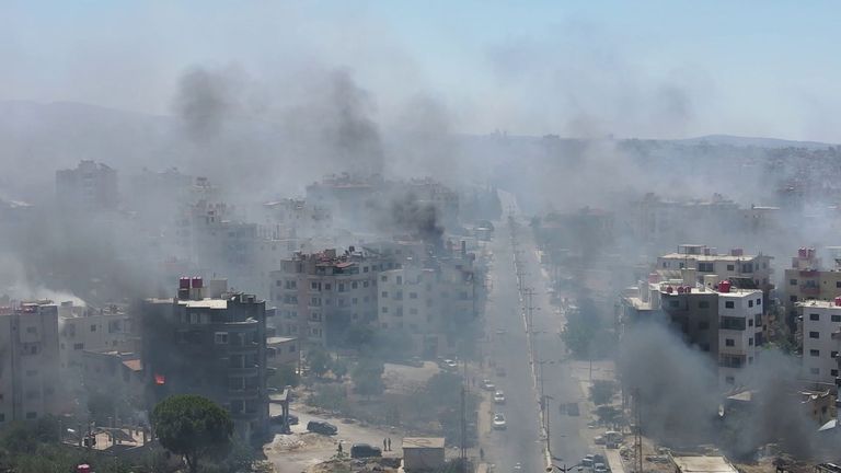 Smoke rises from buildings in the city centre of Sweida
