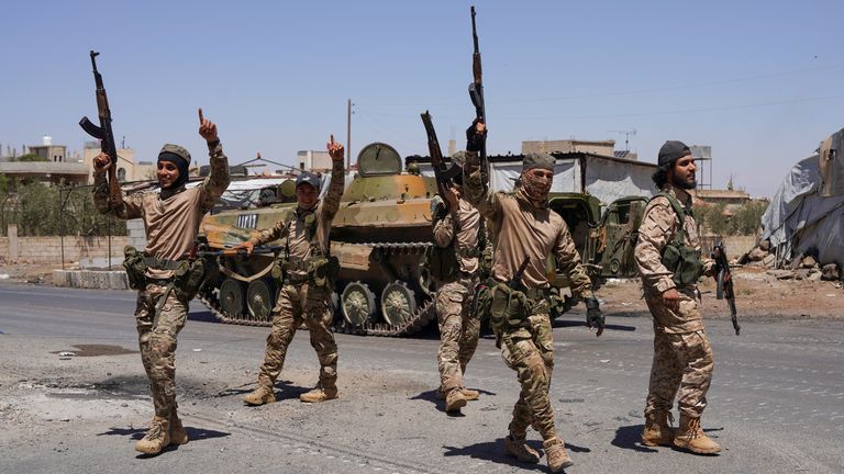 Syrian security forces walk together along a street in the southern Druze city of Sweida.
Pic: Reuters