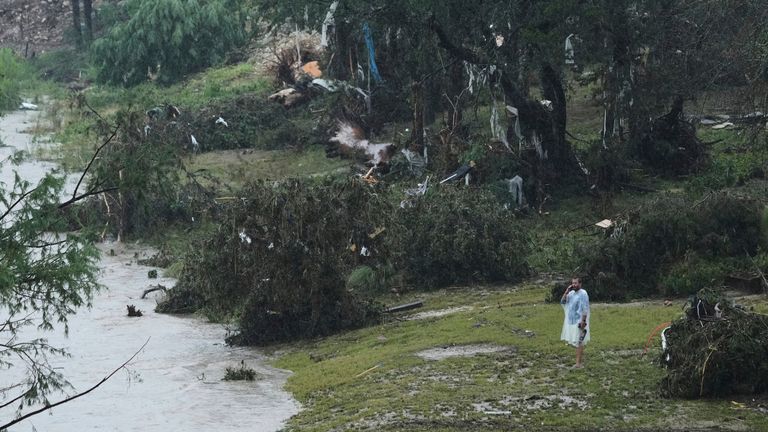 A man surveys damage left by a raging Guadalupe River, Friday, July 4, 2025, in Kerrville, Texas. (AP Photo/Eric Gay)