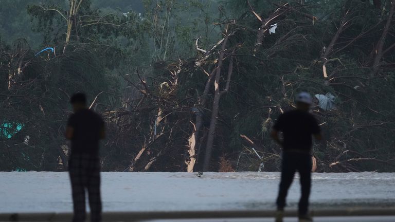 Onlookers survey damage caused along the Guadalupe River in Kerrville, Texas. Pic: AP/Eric Gay