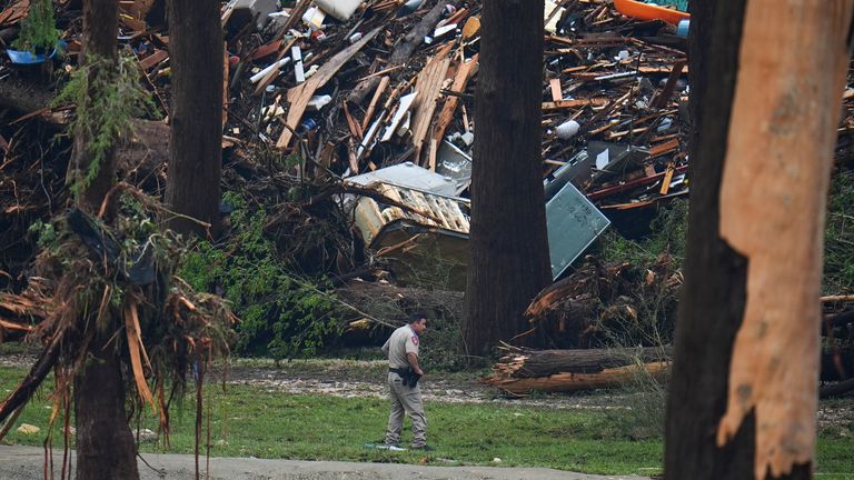 Officials comb through the banks of the Guadalupe River in Hunt, Texas. Pic: AP/Julio Cortez