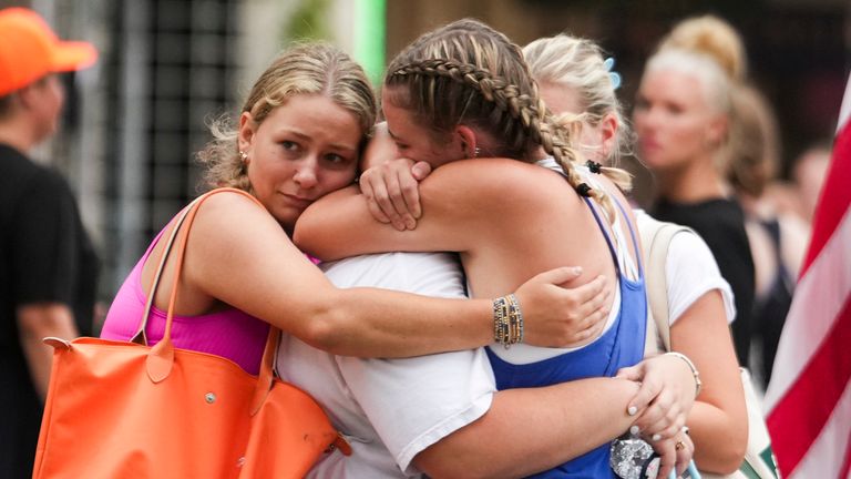 Campers from Camp Waldemar embrace after arriving at a reunification area. Pic: Jason Fochtman/Houston Chronicle via AP