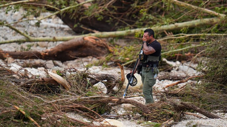 A Sheriff's deputy pauses while searching for the missing in Hunt, Texas.Pic: AP/Julio Cortez