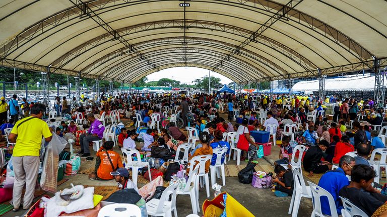 People wait in line to receive food at a shelter in Buriram, Thailand.
Pic: Reuters