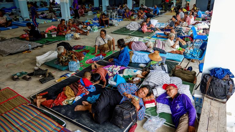 People rest at a shelter, following recent clashes along the disputed border between the two countries, according to authorities people have