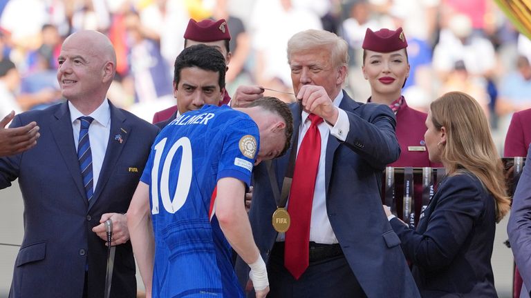 Donald Trump gives Cole Palmer his winner's medal. Pic: AP
