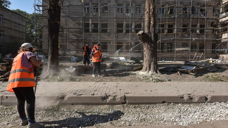 Workers clear debris after a strike on a hospital in Kamianske, Dnipro. Pic: Reuters