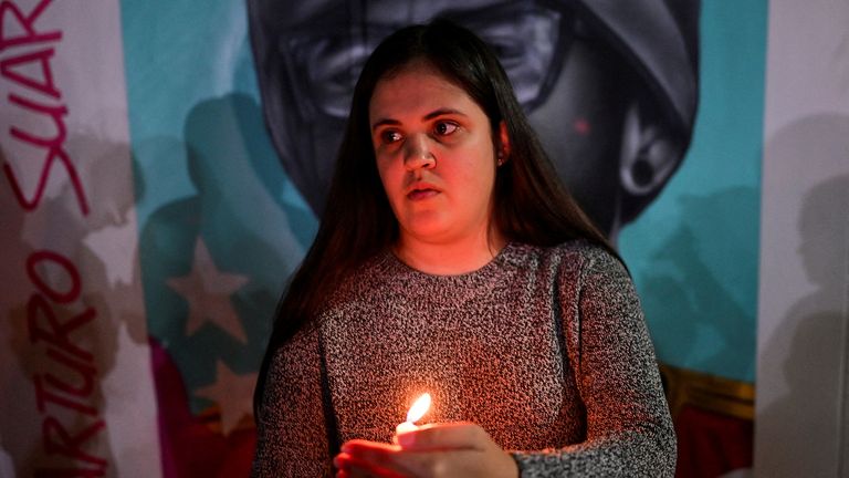Paola Paiva holds a vigil for brother Arturo Suarez. Pic: Reuters