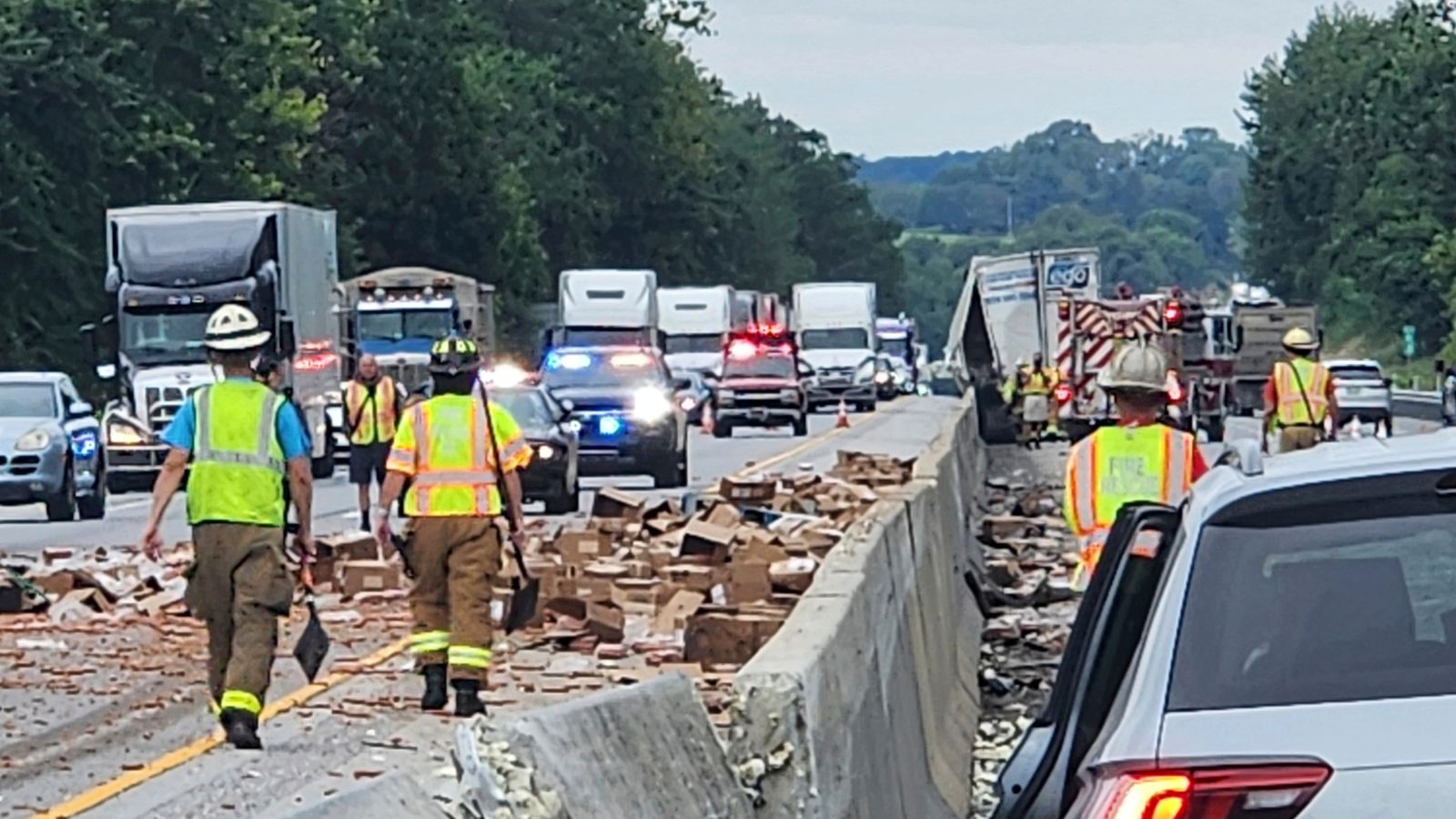 Thousands of hot dogs spill across busy highway