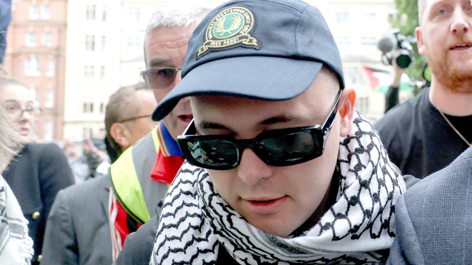Kneecap rapper greeted by hundreds of supporters as he arrives at court on terror charge