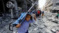 A Palestinian boy after an Israeli strike on a house in Gaza City on Friday. Pic: Reuters