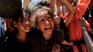 Palestinians wait to receive food from a charity kitchen in Khan Younis. Pic: Reuters