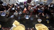 Palestinians wait to receive food from a charity kitchen, in Gaza City, August 15, 2025. REUTERS/Dawoud Abu Alkas