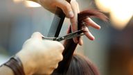 Hairdresser trimming blond hair with scissors. Pic: iStock