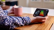 A woman holding an energy smart meter. Pic: iStock