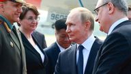 Vladimir Putin shakes hands with officials during a welcoming ceremony in China. Pic: Reuters