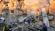 Firefighters work on the site of a burning building after a Russian attack in Kyiv, Ukraine. Pic: AP