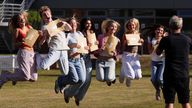 Students jump for a photo after receiving their A-level results at Solihull School