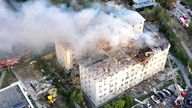 Smoke rises from damaged buildings, at the site of the Russian drone strike in Kharkiv.
Pic: Emergency Service of Ukraine/Reuters