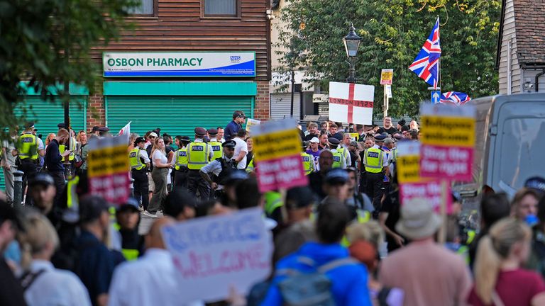 Police officers separate people taking part in the Stand Up To Racism rally and counter protesters in Orpington. Pic: PA