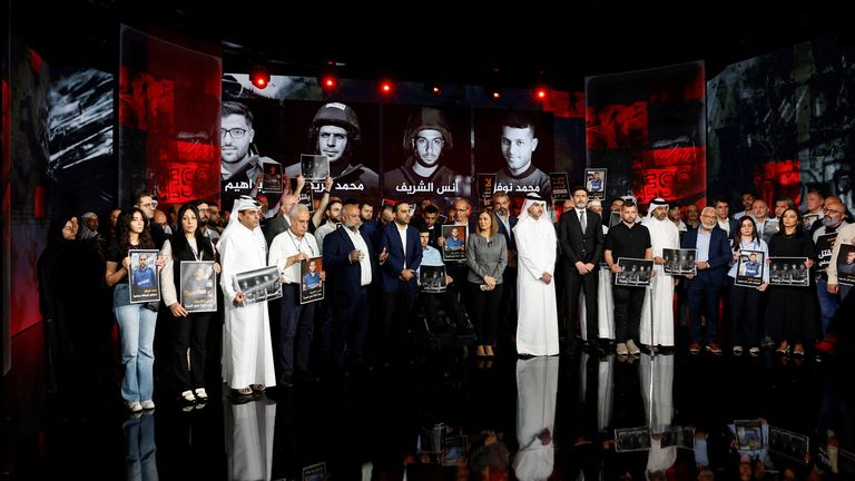 Al Jazeera staff members gather at the network's studios, to remember their colleagues. Pic: Reuters