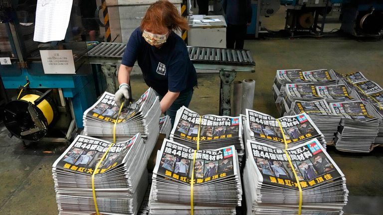 A worker packs copies of Apple Daily newspaper. Pic: AP