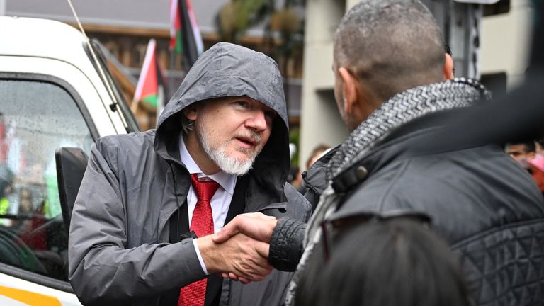 WikiLeaks founder Julian Assange joins protesters gathering to walk across the Sydney Harbour Bridge. Pic: AAP/Dean Lewins/Reuters