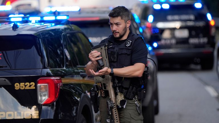 An armed police officer at the scene. Pic: AP