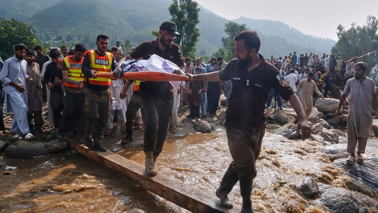 Rescuers transport a victim's body in Buner, Pakistan on Saturday. Pic: AP