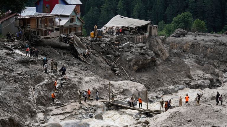 Stranded pilgrims in the village are helped to safety. Pic: AP