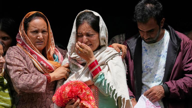 A woman mourns the death of her relative killed in flooding. Pic: AP
