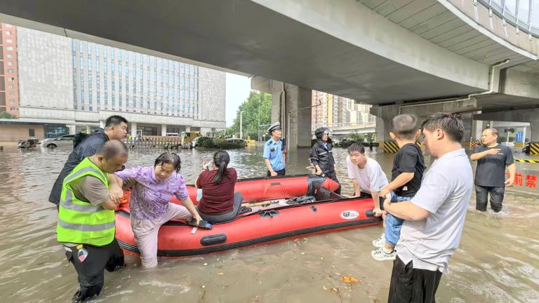People being rescued in Zhengzhou on Thursday. Pic: FeatureChina/AP