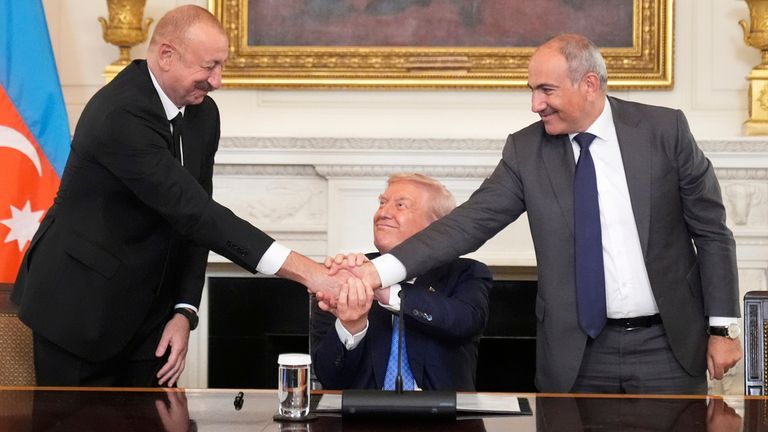 Donald Trump shakes hands with Armenian Prime Minister Nikol Pashinyan, (right) and Azerbaijan President Ilham Aliyev. Pic: AP