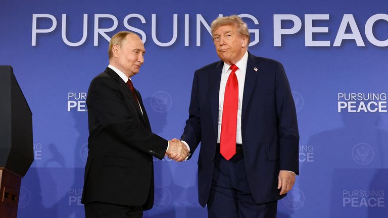 Trump avoids Putin's gaze at the news conference. Pic: AP