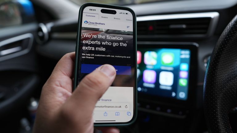 A man looks at an advertisement for car finance. The Supreme Court is to rule on Friday on whether millions of motorists could be entitled to compensation on their hire-purchase agreements. In October last year, the Court of Appeal ruled that "secret" commission payments to car dealers as part of finance arrangements made before 2021 without the motorist's fully informed consent were unlawful. Picture date: Friday August 1, 2025. PA Photo. Photo credit should read: Jonathan Brady/PA Wire 